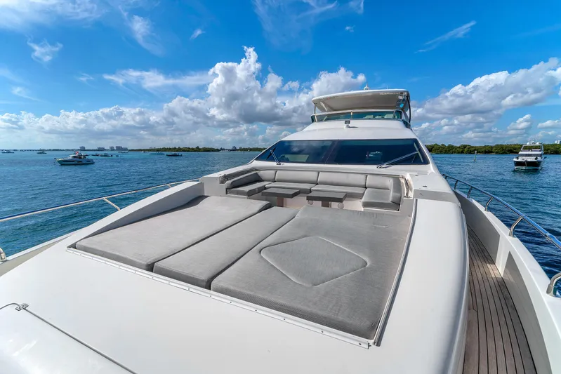 Bt2 Yacht Photos Pics Luxurious 2010 Azimut 95 yacht with spacious sun deck, cruising on a clear blue sea.