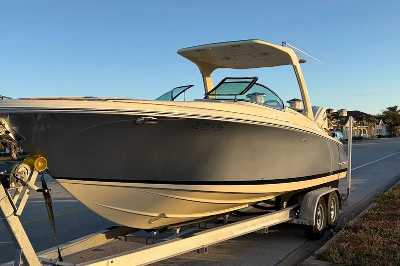  Yacht Photos Pics 2020 Chris-Craft Launch 28 boat on trailer, parked on a sunny street.