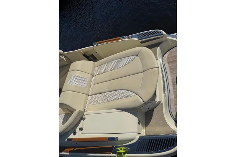  Yacht Photos Pics 2020 Chris-Craft Launch 28 boat with beige cushioned seating, docked on water.