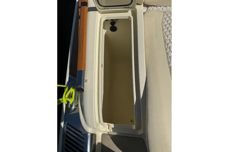  Yacht Photos Pics 2020 Chris-Craft Launch 28 boat storage compartment with beige interior and wooden accents.