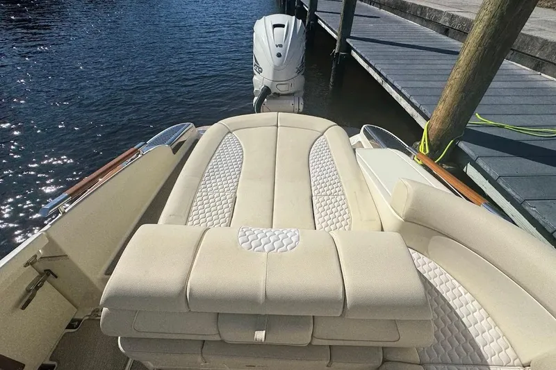  Yacht Photos Pics 2020 Chris-Craft Launch 28 boat with luxurious seating, docked by the water.