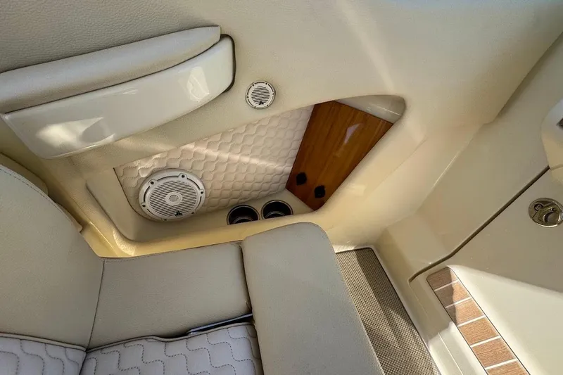  Yacht Photos Pics 2020 Chris-Craft Launch 28 interior with beige upholstery and speaker detail.