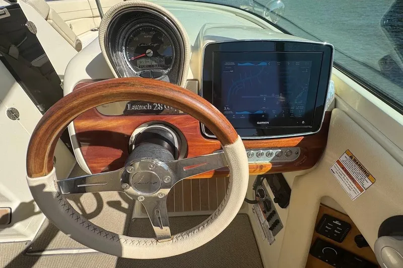  Yacht Photos Pics 2020 Chris-Craft Launch 28 dashboard with steering wheel and Garmin navigation display.
