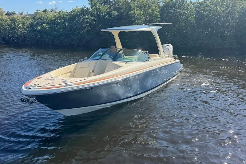  Yacht Photos Pics 2020 Chris-Craft Launch 28 boat cruising on a sunny day in calm waters.