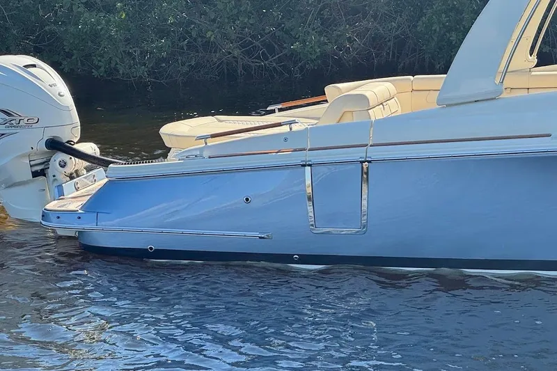  Yacht Photos Pics 2020 Chris-Craft Launch 28 boat with outboard motor on calm water.