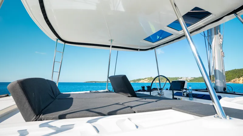 Infinity Yacht Photos Pics 2023 Lagoon 46 yacht deck with sun loungers and ocean view.