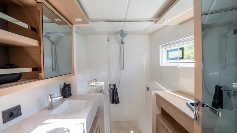 Infinity Yacht Photos Pics Modern bathroom interior on 2023 Lagoon 46 yacht, featuring sleek design and natural lighting.
