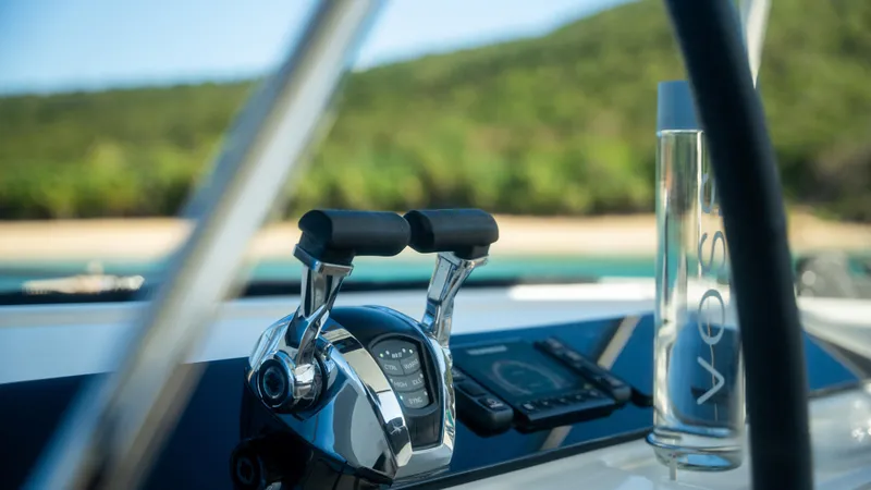 Infinity Yacht Photos Pics Close-up of 2023 Lagoon 46 yacht controls with a scenic background.