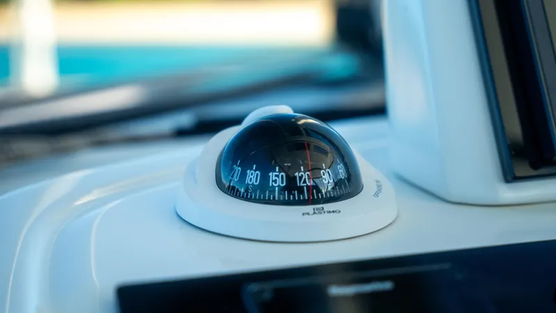 Infinity Yacht Photos Pics Compass on 2023 Lagoon 46 yacht dashboard, close-up view.