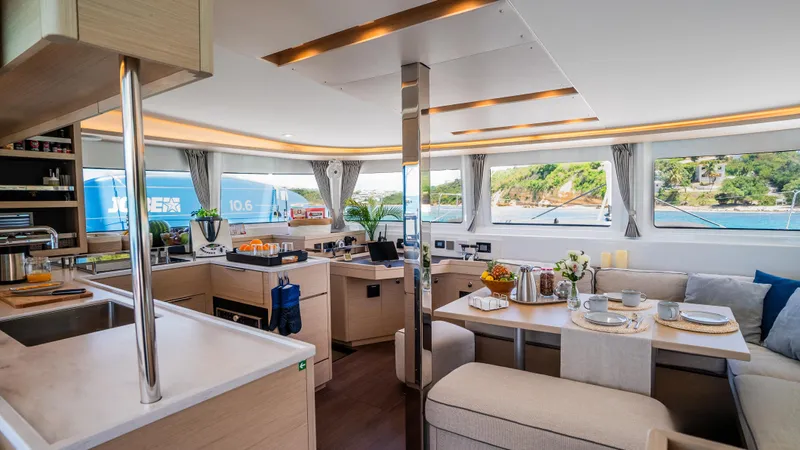 Infinity Yacht Photos Pics Luxurious interior of 2023 Lagoon 46 catamaran with modern kitchen and dining area.