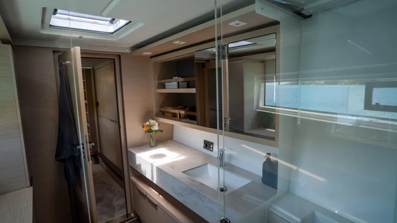 Infinity Yacht Photos Pics Luxurious bathroom interior of 2023 Lagoon 46 yacht with modern fixtures and natural lighting.