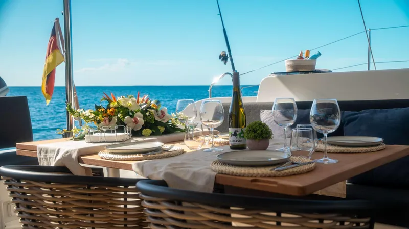 Infinity Yacht Photos Pics Luxurious dining setup on a 2023 Lagoon 46 yacht with ocean view.