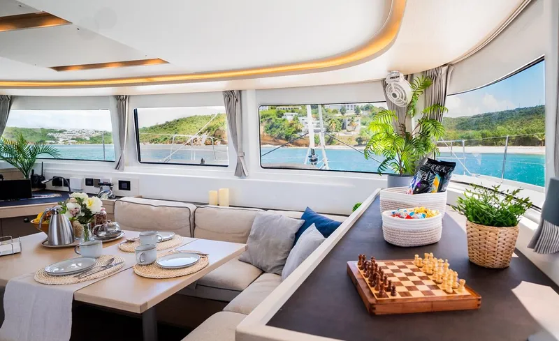 Infinity Yacht Photos Pics Luxurious interior of 2023 Lagoon 46 catamaran with scenic ocean view and elegant decor.