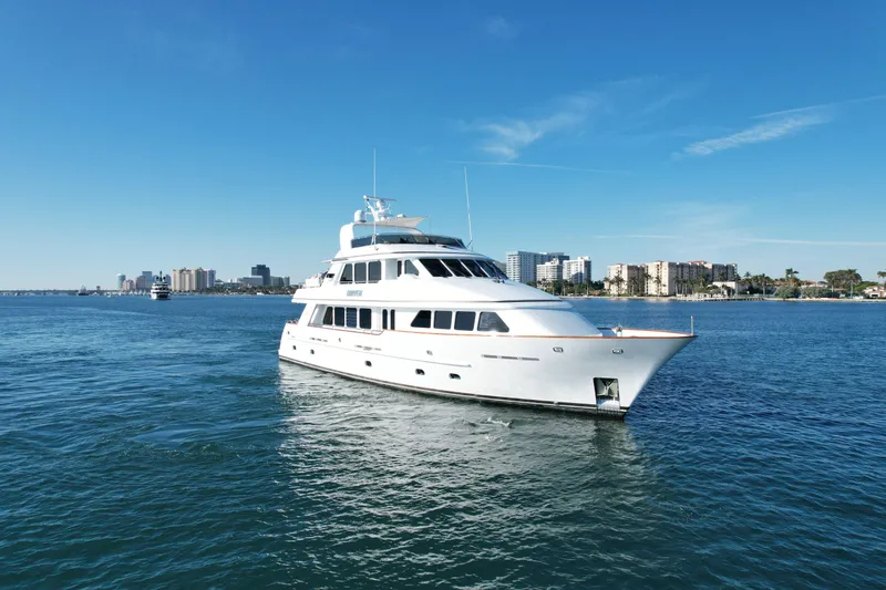 Driven Yacht Photos Pics Luxury Conrad 88 yacht from 2005 cruising on a sunny day near city skyline.