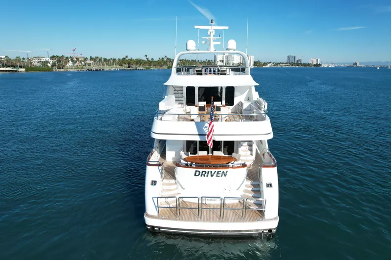 Driven Yacht Photos Pics Luxurious Conrad 88 yacht from 2005 on serene blue waters, rear view.