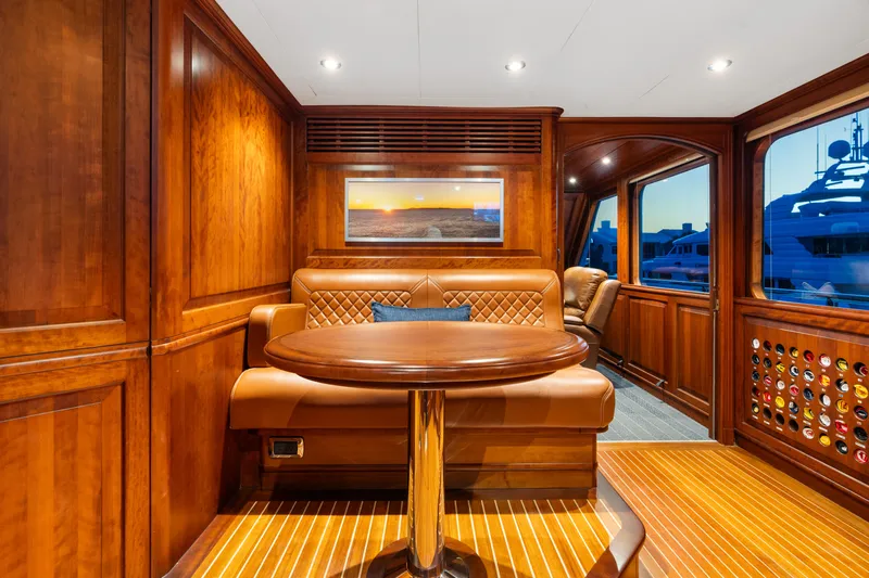 Driven Yacht Photos Pics Luxurious wooden interior of a 2005 Conrad 88 yacht with elegant seating and table.