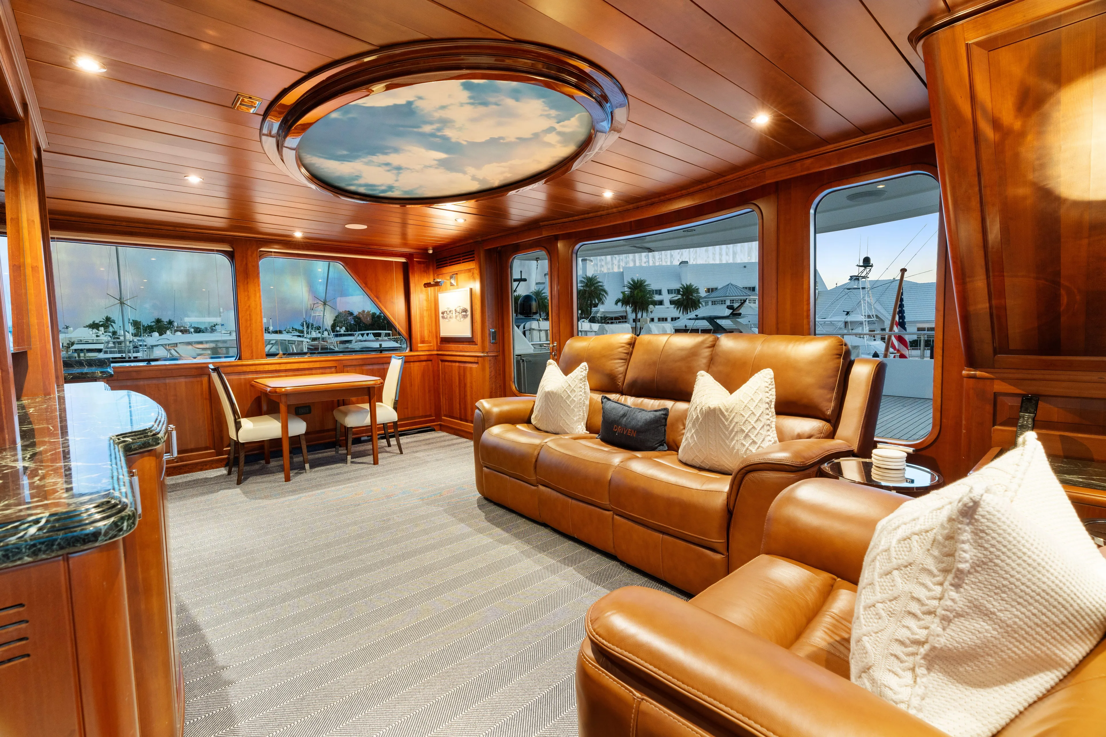 Driven Yacht Photos Pics Luxurious interior of 2005 Conrad 88 yacht with leather seating and elegant wood paneling.