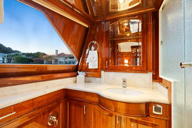 Driven Yacht Photos Pics Luxurious wooden yacht bathroom interior, Conrad 88, 2005 model, with elegant fixtures and scenic window view.