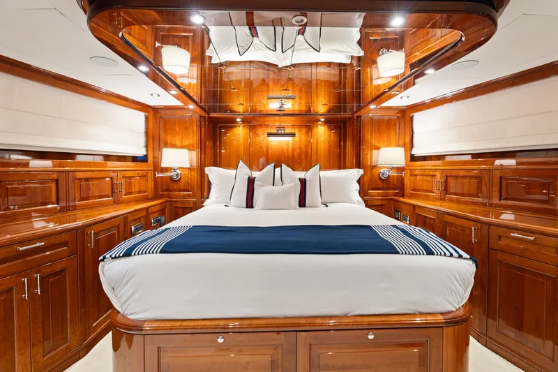 Driven Yacht Photos Pics Luxurious wooden cabin interior of a 2005 Conrad 88 yacht with elegant bedding.