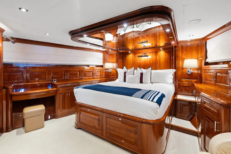 Driven Yacht Photos Pics Luxurious wooden yacht bedroom interior, Conrad 88, 2005 model, featuring elegant furnishings and ambient lighting.