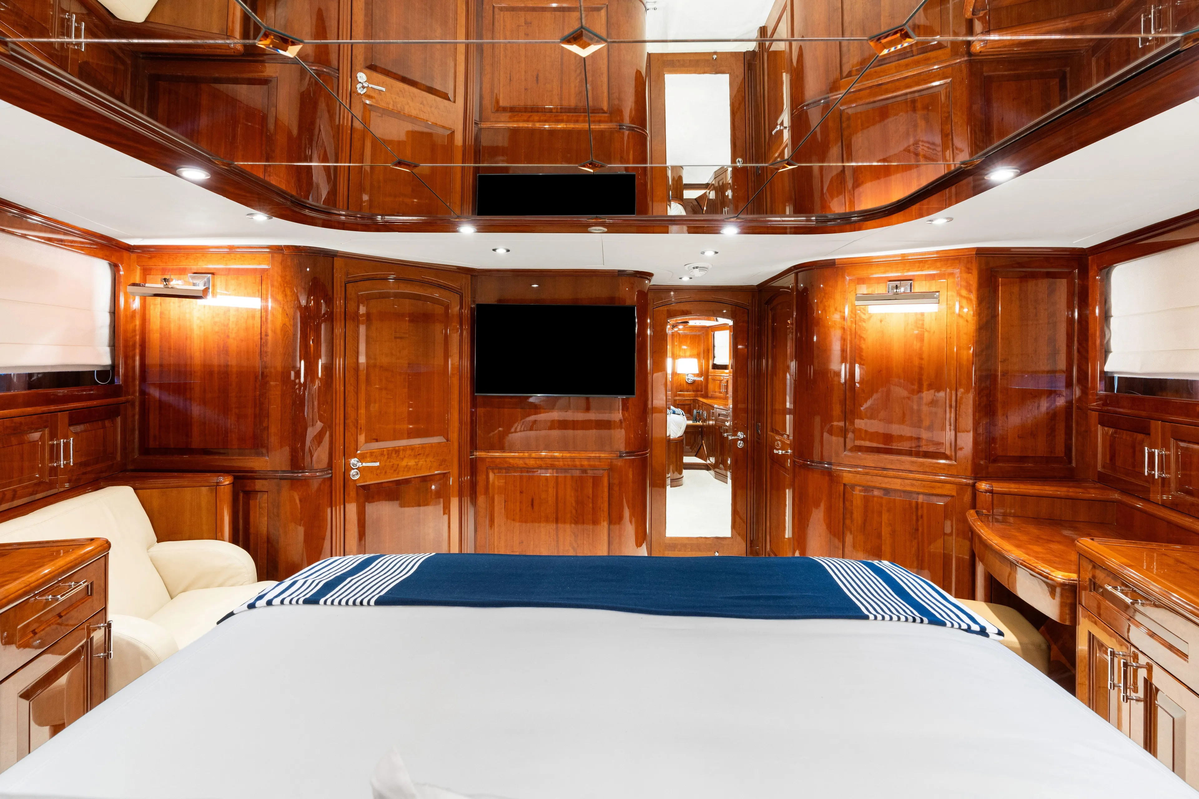 Driven Yacht Photos Pics Luxurious wooden interior of a 2005 Conrad 88 yacht bedroom with elegant furnishings.