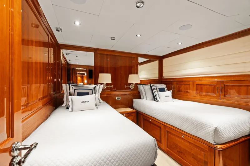Driven Yacht Photos Pics Luxurious twin cabin interior on a 2005 Conrad 88 yacht, featuring elegant wood paneling.