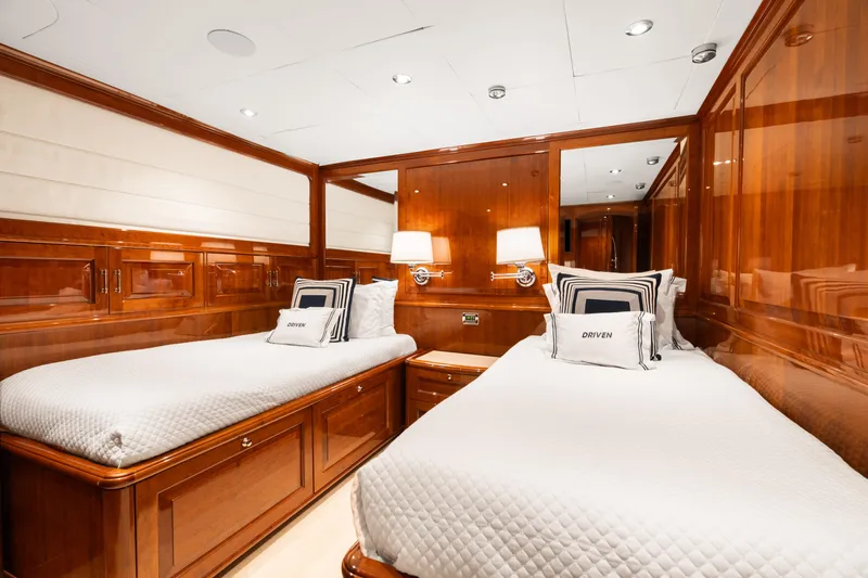 Driven Yacht Photos Pics Luxurious twin cabin with wooden paneling on a 2005 Conrad 88 yacht.