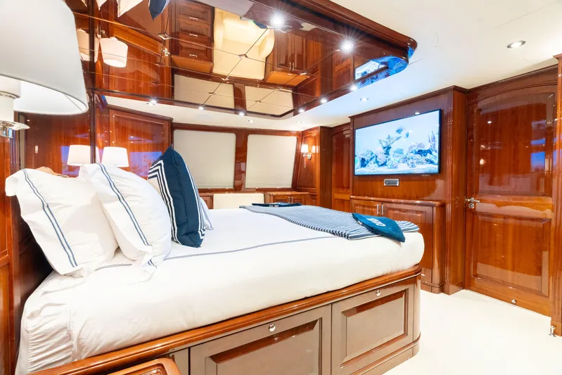 Driven Yacht Photos Pics Luxurious yacht bedroom with wooden interior, Conrad 88 model, 2005, featuring a cozy bed and TV.