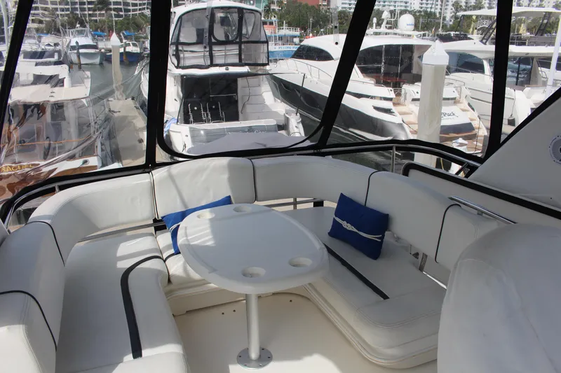 Passst Times Yacht Photos Pics 2005 Sea Ray 420 Sedan Bridge yacht interior with white seating and marina view.