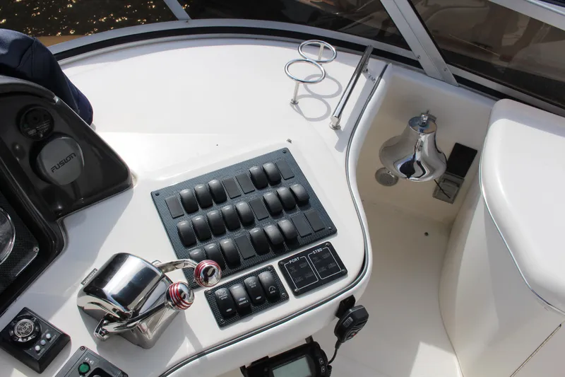 Passst Times Yacht Photos Pics Control panel of a 2005 Sea Ray 420 Sedan Bridge yacht, featuring switches and throttle controls.