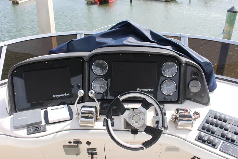 Passst Times Yacht Photos Pics 2005 Sea Ray 420 Sedan Bridge helm with Raymarine electronics and dual throttle controls.