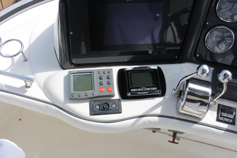 Passst Times Yacht Photos Pics Control panel of 2005 Sea Ray 420 Sedan Bridge with navigation instruments and throttle controls.