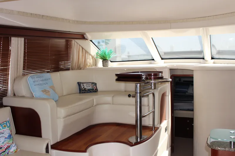 Passst Times Yacht Photos Pics Luxurious interior of 2005 Sea Ray 420 Sedan Bridge yacht with plush seating and elegant decor.