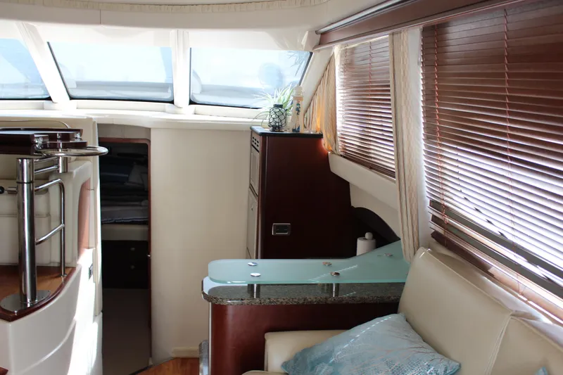 Passst Times Yacht Photos Pics Interior of 2005 Sea Ray 420 Sedan Bridge yacht with modern furnishings and large windows.