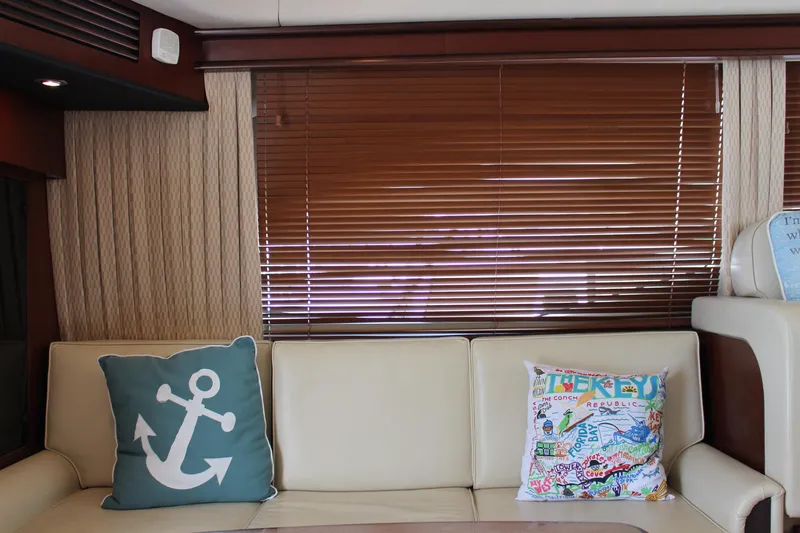 Passst Times Yacht Photos Pics Interior of 2005 Sea Ray 420 Sedan Bridge with anchor-themed decor and colorful pillows.