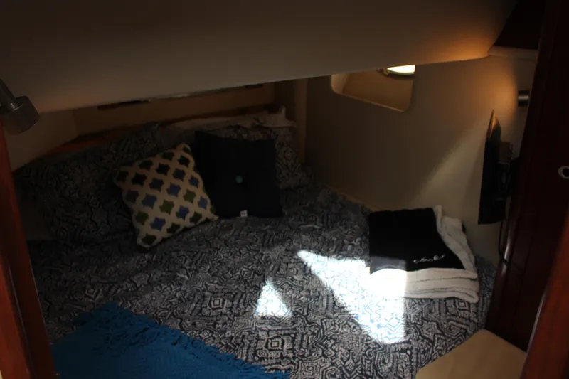 Passst Times Yacht Photos Pics Cozy cabin interior of 2005 Sea Ray 420 Sedan Bridge with patterned bedding and pillows.