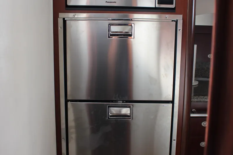 Passst Times Yacht Photos Pics Stainless steel refrigerator in 2005 Sea Ray 420 Sedan Bridge yacht interior.