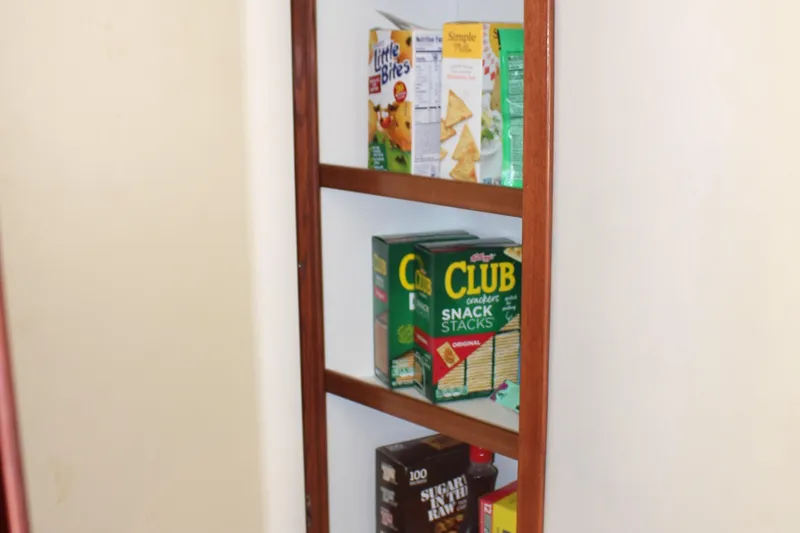 Passst Times Yacht Photos Pics Shelf with assorted snack boxes on a Sea Ray 420 Sedan Bridge, 2005 model.