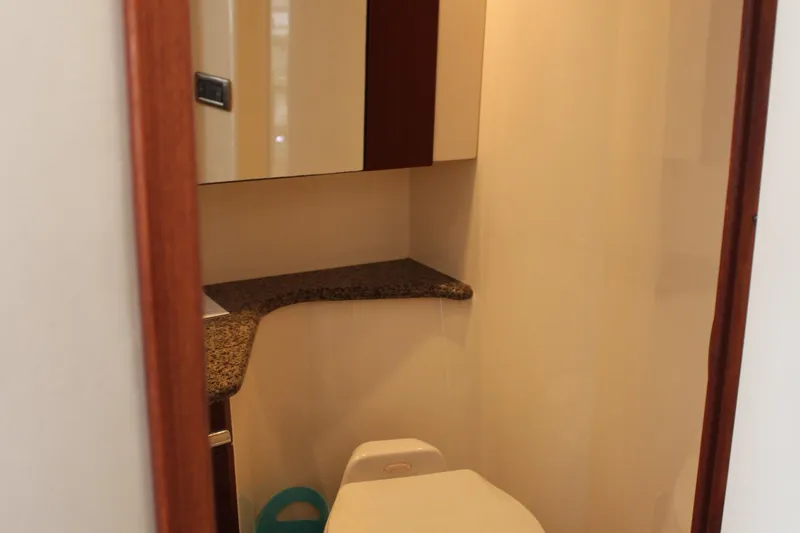 Passst Times Yacht Photos Pics Bathroom interior of 2005 Sea Ray 420 Sedan Bridge yacht, featuring compact design and modern fixtures.