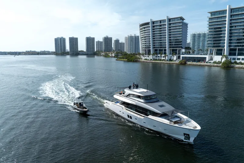 Mave Yacht Photos Pics Sanlorenzo SX88 yacht cruising near modern waterfront buildings, 2020 model.