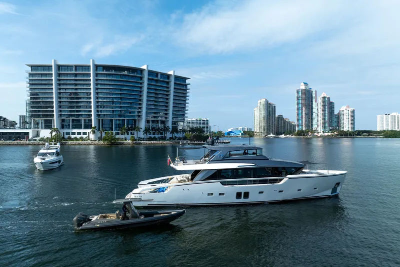 Mave Yacht Photos Pics Luxurious 2020 Sanlorenzo SX88 yacht cruising near modern waterfront buildings.