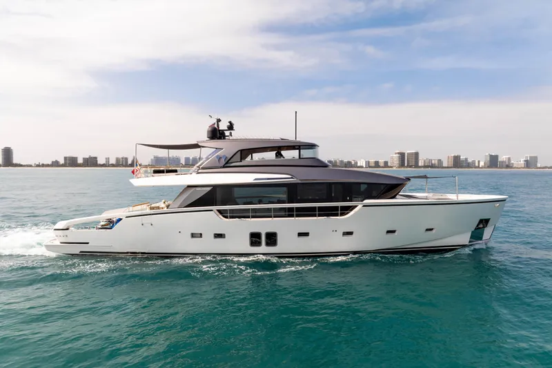 Mave Yacht Photos Pics Luxury 2020 Sanlorenzo SX88 yacht cruising on open water with city skyline backdrop.
