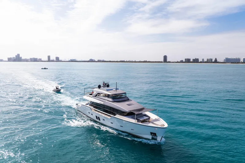 Mave Yacht Photos Pics 2020 Sanlorenzo SX88 yacht cruising on blue ocean near city skyline.