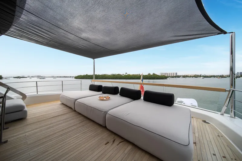 Mave Yacht Photos Pics Luxurious 2020 Sanlorenzo SX88 yacht deck with modern seating and scenic waterfront view.