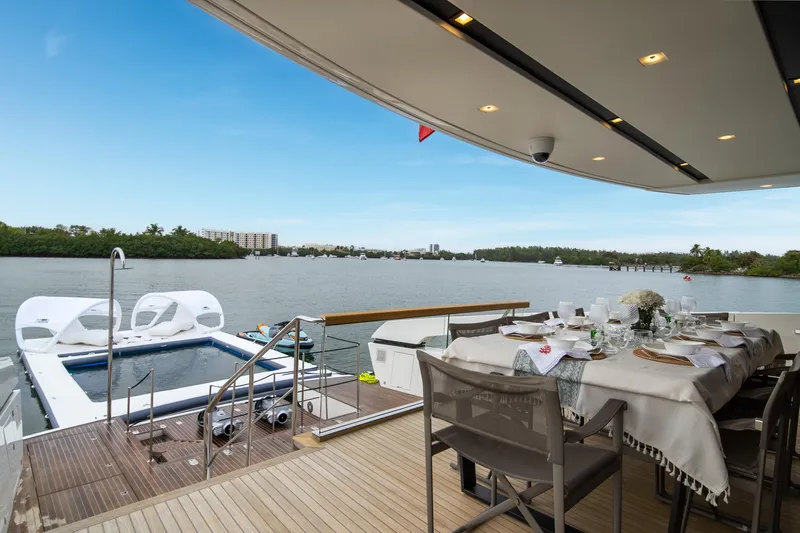 Mave Yacht Photos Pics Luxurious 2020 Sanlorenzo SX88 yacht deck with dining area and scenic waterfront view.