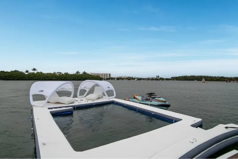 Mave Yacht Photos Pics Luxury Sanlorenzo SX88 yacht with floating pool and jet ski, 2020 model, on serene water.