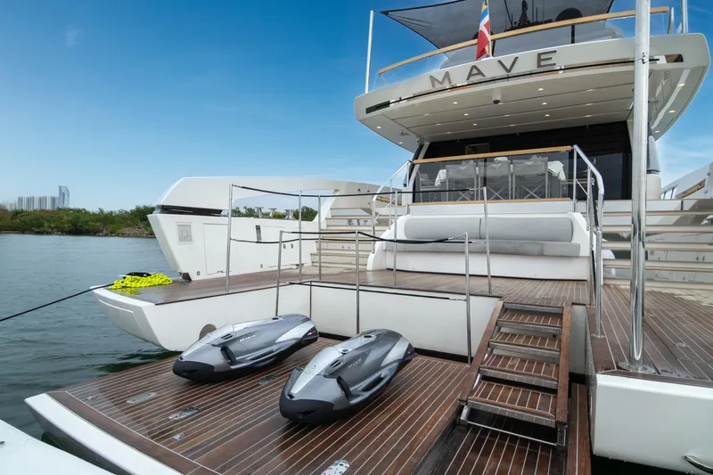 Mave Yacht Photos Pics Luxury Sanlorenzo SX88 yacht, 2020 model, with jet skis on the deck, docked by the water.
