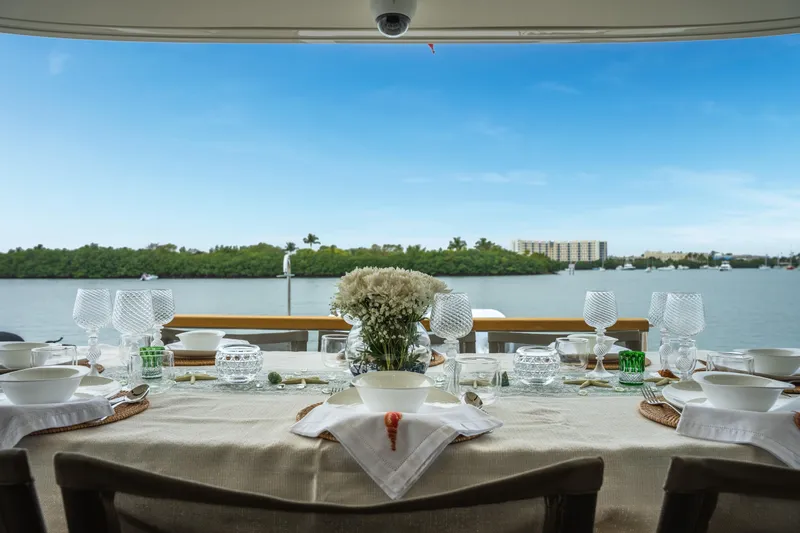 Mave Yacht Photos Pics Elegant dining setup on Sanlorenzo SX88 yacht, overlooking serene waterfront view.