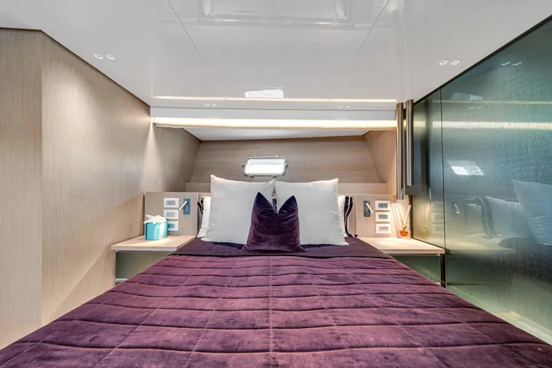 Mave Yacht Photos Pics Luxurious Sanlorenzo SX88 2020 yacht bedroom with plush purple bedding and modern decor.