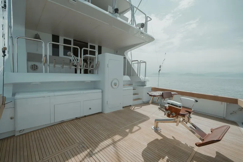 Aussie Rules Yacht Photos Pics Luxurious 1996 Oceanfast 87 Enclosed Bridge yacht deck with fishing chair and ocean view.